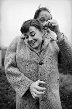 Audrey Hepburn and Mel Ferrer sharing a coat.