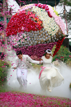 A memorable day (Prasit and Varutton Rangsitwong run away from a giant flower ball as a part of their adventure-themed wedding ceremony in Prachinburi province, Thailand, on the eve of Valentine’s Day)