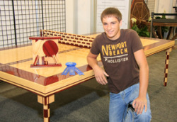 woodworkerted:  Found some more photo’s of the young woodworker behind this beauty  http://awfsfair.org/freshwood-winners-2011/17-first-place-hs-tables-padauk-and-ash-greg-moore/