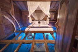 mymodernmet:   This bedroom may be one of the most unique sleeping quarters ever. Part of the Udang House (or Shrimp House) at the Bambu Indah hotel in Ubud, Bali, the one-of-a-kind room has tempered glass floor panels that reveal a stunning underwater