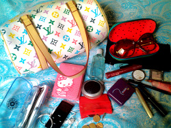 fuckyeahwhatsinyourbag:  My dad found this Louis Vuitton bag in a trash can somewhere near his job. So, in my bag you can find.. my Kipling glasses, my iPod nano, my Hello Kitty wallet, this little red thingy for coins (I don’t know the name in English