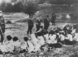 German police and Ukrainian collaborators force Jews to undress, 1942.