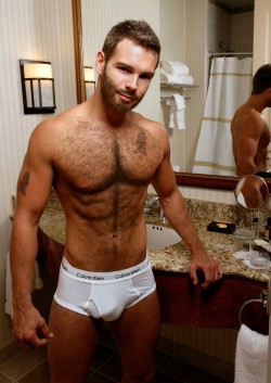 puphawaii:  clotheslessdudes:  apollosbelt:  Delicious hairy stud in tighty whites   This right here…dream body and beard.   wanna drop down and chew on his bone thru the pouch ..  