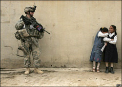  rainydayraised:  A girl becomes embarrassed after giving flowers to a female US soldier on duty in the northern Iraqi city of Mosul. 16 April 2007      