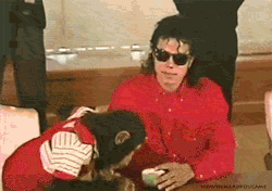  Michael Jackson tells Bubbles the chimp in sign language to sit the fuck down and stop stealing sips of his tea.  
