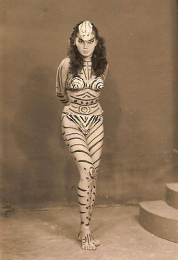 awfulsimiangorillamonkey: hoodoothatvoodoo:  Dancer Rose Chan writhes in a snake “costume” that has stirred up a  furor in Penang, Malaya. Her costume is mostly grease paint striped over  her body, which is clothed only in a Bikini bathing suit. The