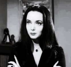 Morticia Addams.  The Carolyn Jones TV version.  Big doe eyes.  Great curves squeezed in a tight dress she could barely walk in.  Devoted wife that oozed sexuality.