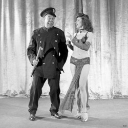 Burly-Q comic Bert Lahr hams it up as a policeman, in a skit with an unknown dancer..