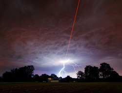 jtotheizzoe:  Humans fire laser to sky, sky laughs, responds with lightning (They were actually firing a kind of “guide star” that is used to target and correct ground-based telescopes when this shot happened. Nature is still not impressed) (via Short