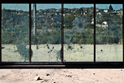 matimilstein:  Through the Looking Glass  The Mexican city of Juarez as seen through a bullet-pocked protective barrier from the American side of the international border. Ciudad Juarez has been plagued by drug-related violence and thousands of murders