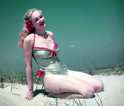 Lynne O’Neill models her silver lamé swimsuit in the dunes, somewhere on one of Long Island’s many beaches..