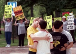 atheismandbeautifulthings:  atheismandbeautifulthings-blog:  LGBT students kissing in front of protesters from Westboro Baptist Church at Oberlin College in Oberlin, Ohio. The students were among several hundred who turned out in May 2000 to rally