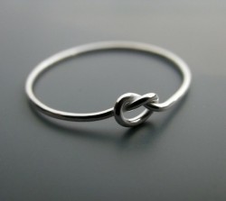 t0-infinity-and-69:     A “knot” ring. The ring symbolizes a knot that is not quite tied yet, but has all intentions of being tied. A promise ring.     Want. 
