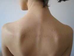  Braille subdermal implants.  Directly translates to, “No sky no earth but still snowflakes fall” 