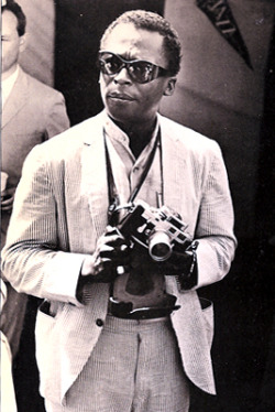 Celebritycameraclub:  Miles Davis With His Leica M3 Fitted With A Selenium Meter.