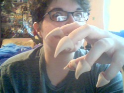 Ugly webcam pics of my claws. Hurr, they look like Hershey kisses. They&rsquo;re going to poke through the fingers of my glove, so you&rsquo;re probably only going to see the claw part. I also wanted them to be kinda chunky and thick looking. They&rsquo;r