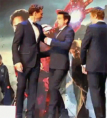 jamcake15:  booshbaby:  Robert Downey Jr. and Tom Hiddleston share a moment together on stage while Jeremy Renner feels like the third wheel.   I think Tom is thinking of kissing him omg. xD He should have kissed him on the head just to send a really