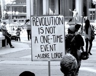 [Sign with quote by Audre Lourde: “Revolution is not a