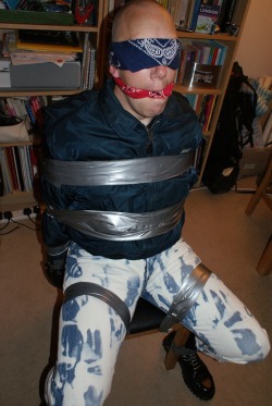 metalinkskin:  strictprotocol:  Skinhead bound and gagged with duct tape  Can never have too much duct tape spent last night this but instead with industrial cable ties &amp; lthr hood over gag 