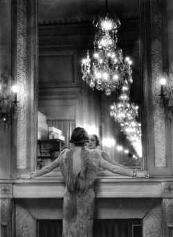 onlyoldphotography:  Alfred Eisenstaedt: Model in ostrich feather-trimmed gown pausing to regard herself in grand mirror of the Molyneux atelier. Paris, France, 1934 
