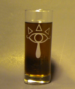 thedrunkenmoogle:  The Legend of Zelda - Sheikah Highball GlassCreated by MCEtching - บ.00 Zeldapedia explains, “The emblem of the Sheikah resembles a human eye, with three triangles above it (as if to imitate eyelashes and/or symbolize the pieces