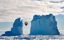 m0iety:  Michelle Valberg “This photo was taken on the ice near Arctic Bay last month. As far as we know, it is the highest latitude passenger flight on a hot air balloon ever. It was quite the sight to see a hot air balloon fly between the iceberg