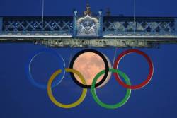 jtotheizzoe:  brooklynmutt:  Whoa! The full moon rises through the Olympic Rings hanging beneath Tower Bridge during the London 2012 Olympic Games August 3, 2012. REUTERS/Luke MacGregor  Now that’s what I call a gold medal photo. 