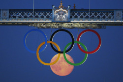  The full moon rises through the Olympic