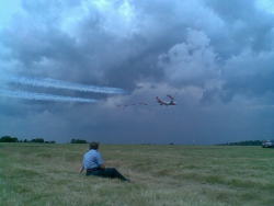 jeffersdailythoughts:  I got to admit this is the best picture i have taken. Biggin Hill 3 years ago while I was stewarding as a cadet. Boeing 747 accompany by a squadron of red arrow. with a flight lieutenant.  