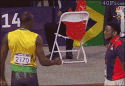  Volunteer at the Olympics reacts to a fist bump from Usain Bolt 
