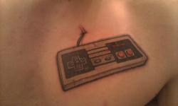 fuckyeahtattoos:  Shortly after being finished. My NES controller tattoo. I’ve been wanting this for the last few years. I got it on my chest above my heart. The games I grew up on and the ones I respect the most are all on the original Nintendo. When