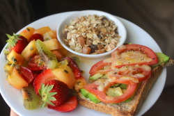 kellie-the-vegetarian:  Lunch: Wholegrain toast topped with avocado, tomato, cheddar cheese and black pepper. Served with fruit salad and muesli 