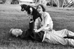   Anthony Michael Hall and Molly Ringwald playing with a puppy during a break in location shooting of The Breakfast Club.                 
