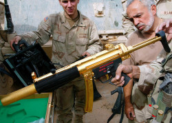 drugwar:  U.S. Army soldiers and a translator inspect a gold plated German-made MP-5 submachine gun that soldiers from A Company 3rd Battalion 7th Infantry Regiment found in another arms cashe they found in Baghdad, Iraq Sunday, April 13, 2003.(AP Photo/J