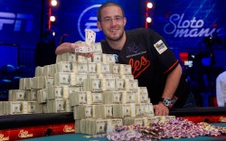 Greg Merson, 24, of Laurel, Maryland poses with Ű.5 million in cash and his championship bracelet after winning the World Series of Poker Main Event at the Rio Hotel &amp; Casino in Las Vegas, Nevada