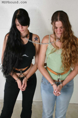 Bondage duo in handcuffs and neckiron.