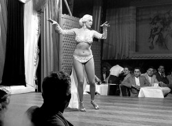 burleskateer:    Mae Blondell     aka. “The Statuesque Blonde”.. Dancing on stage for patrons at a Chicago nightclub, sometime in 1952..   