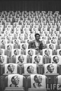 ziingara:   Bill Cosby sitting in empty auditorium filled with copies of his likeness on each seat, Las Vegas, 1968. Photo: Michael Rougier  Love him. Deal with it. 