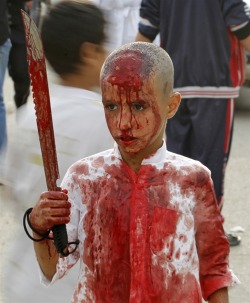 politics-war:  politics-war:  An Iraqi Shiite Muslim child gashes his forehead with a sword during a ceremony marking Ashoura in Baghdad’s Sadr City.    