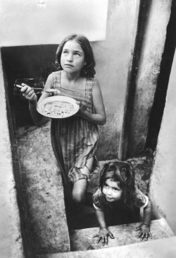 Refugee children in a filthy cellar at Piraeus during the Greek Civil War.