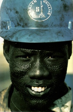 vintagenatgeographic:  Nuer tribesman wears a hard hat for his job on an oil rig in Sudan National Geographic | May 1985 